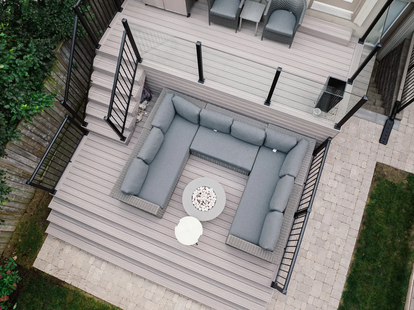 Two-level Fiberon composite deck with contrasting board edges, broad steps and glass and picket guards