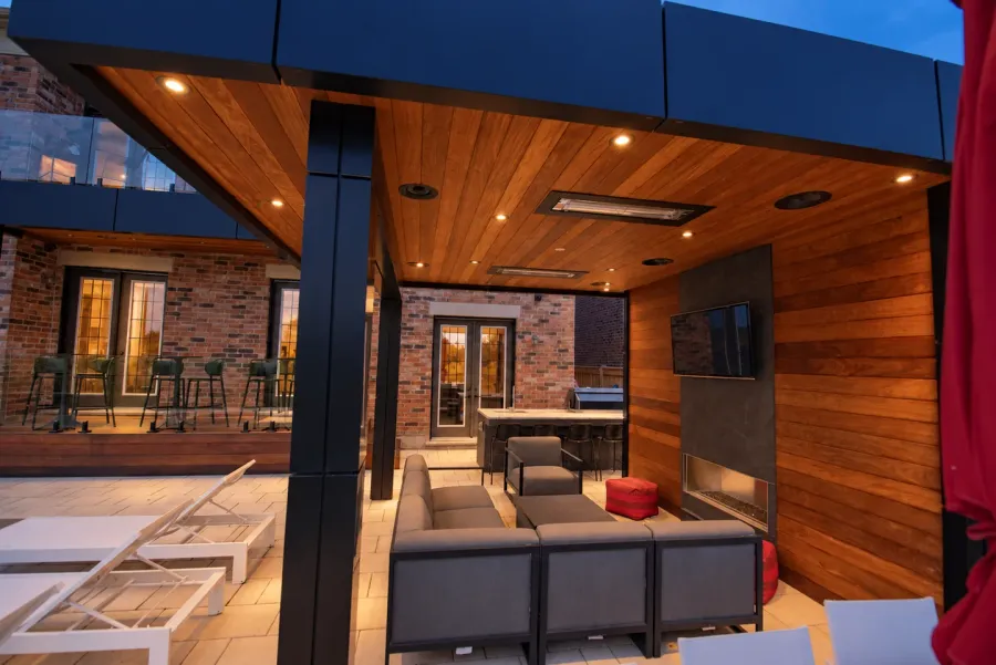 Warm downlights illuminate a wood-lined cabana lounge at dusk; lighting visualization based on a real project