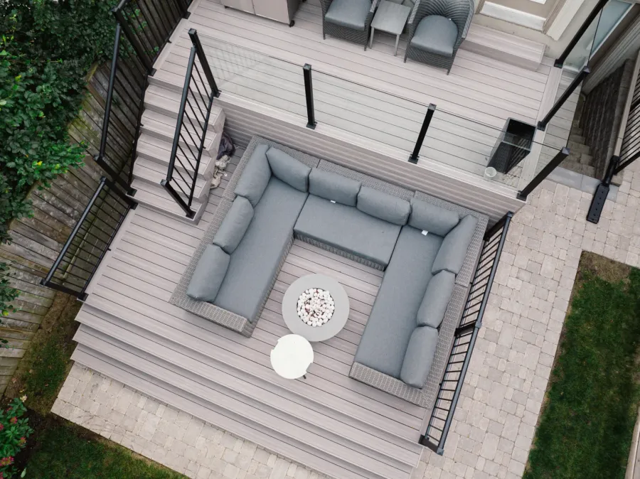 Two-level Toronto deck with clear glass panels and black aluminum picket railings