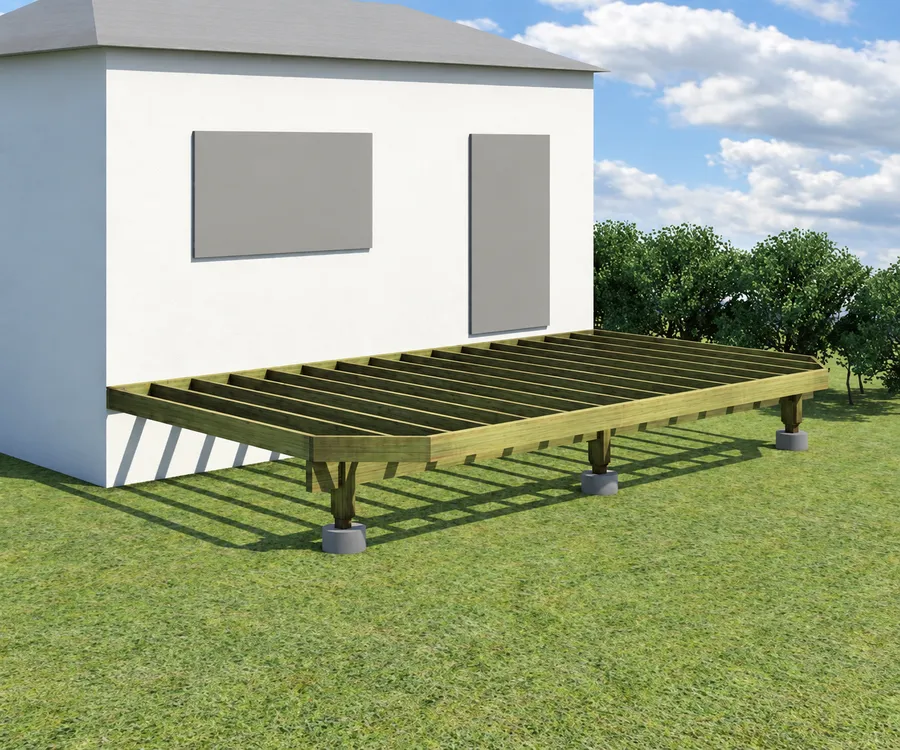 Open deck frame beside a house, showing parallel joists, a perimeter rim and a beam supported by posts on concrete piers